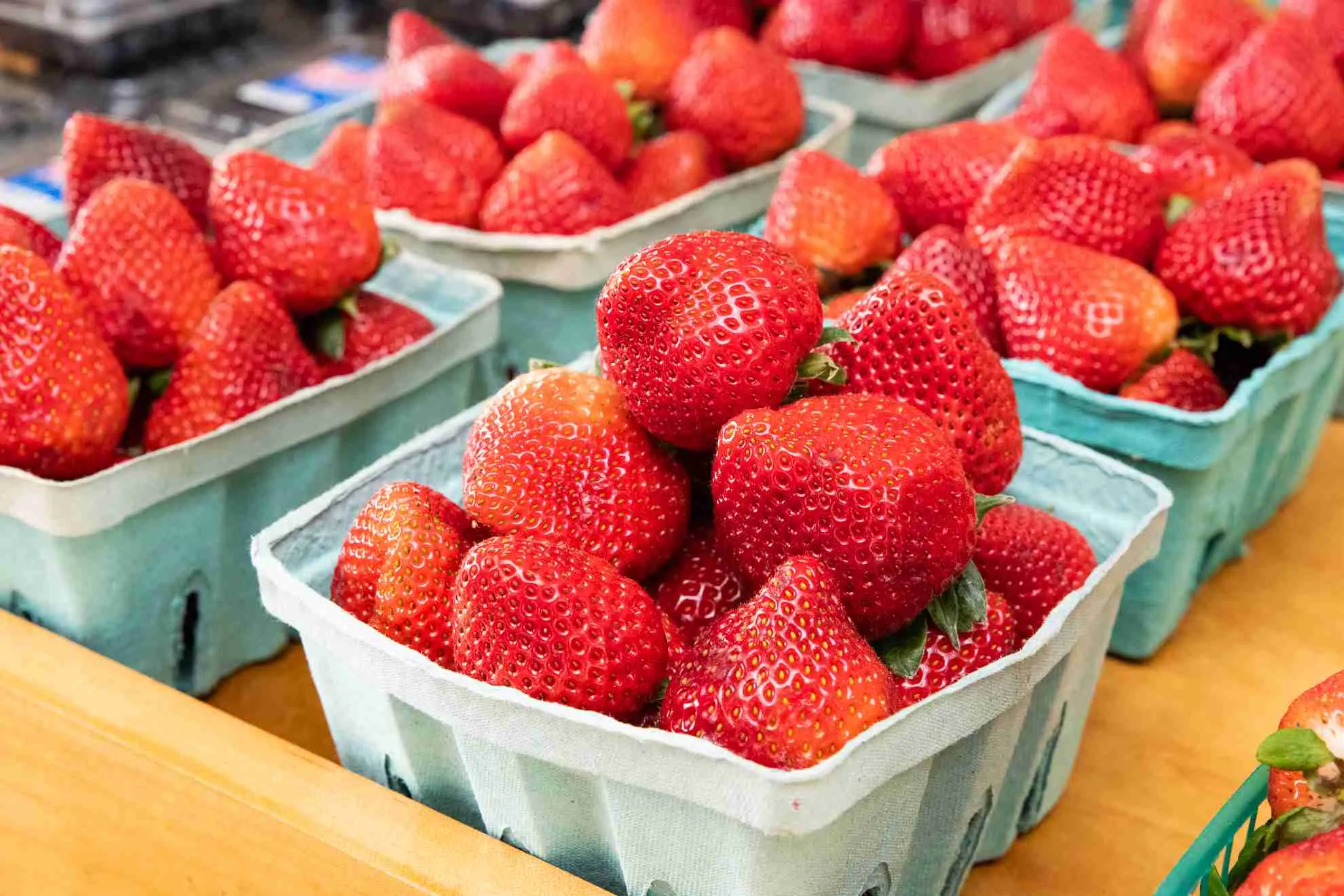 Fresh strawberries displayed in green market cartons at Fiorentino's Farm Market