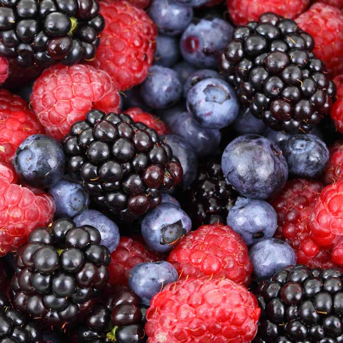 Baskets of ripe berries arranged at a farmers market